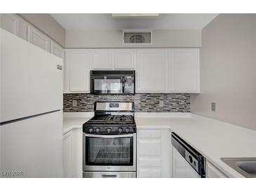 This compact kitchen is equipped with sleek, stainless steel appliances and contrasting backsplash at 3060 Tarpon Dr # 102, Las Vegas, NV 89120