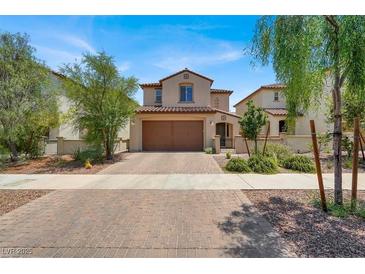 Charming two-story home showcasing a desert landscaped front yard and two-car garage, with a tile roof at 348 Andy Wheeler Dr, Henderson, NV 89011