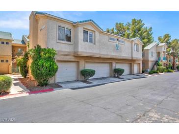 Condominium building exterior shows multi-car garages with low-maintenance desert landscaping at 5155 W Tropicana Ave # 2017, Las Vegas, NV 89103
