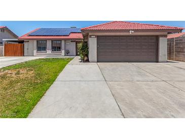 Charming single-story home featuring a red tile roof, solar panels, and a two-car garage at 5734 Duval Dr, Las Vegas, NV 89156