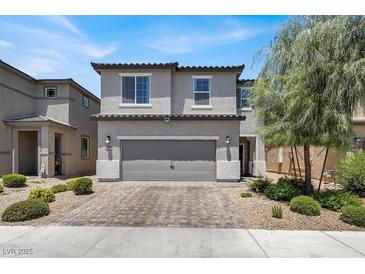 Charming two-story home with a well-maintained front yard and a two-car garage at 6106 Castle Gardens Ave, Las Vegas, NV 89130