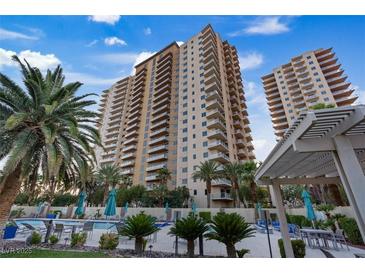 Beautiful condo building with a resort style pool, palm trees, and ample outdoor seating at 8255 Las Vegas Blvd # 1905, Las Vegas, NV 89123