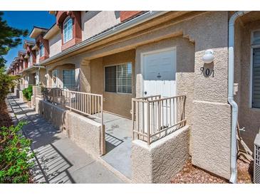 Charming townhouse featuring stucco exterior, private entry, and cozy front patio, creating a welcoming curb appeal at 901 Nevada Sky St, Las Vegas, NV 89128