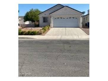 Charming single-story home with a two car garage and well-maintained landscaping in a suburban neighborhood at 9225 Lady Palm Ct, Las Vegas, NV 89147