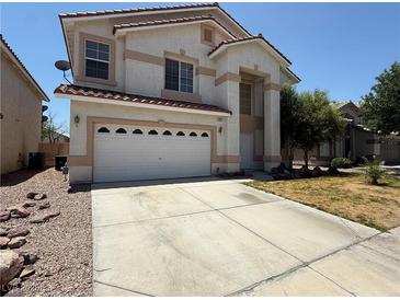 Two story home with a white garage door and concrete driveway at 925 Scarlet Haze Ave, Las Vegas, NV 89183