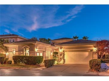 Charming single-story home with a tile roof, an attached two-car garage, and manicured landscaping at 9733 Plateau Heights Pl, Las Vegas, NV 89144