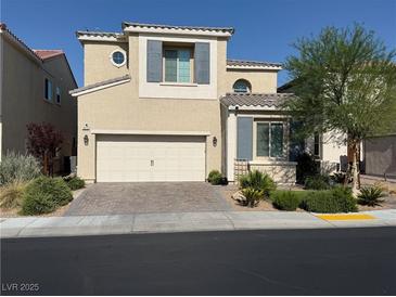 Charming two-story home featuring a neutral color palette, well-kept landscaping, and a brick driveway at 1012 Via Stellato St, Henderson, NV 89011