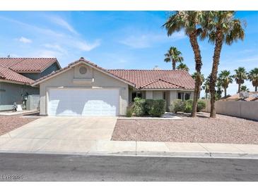 Charming single-story home with a two-car garage and a well-maintained front yard with palm trees at 118 Westin Ln, Henderson, NV 89002