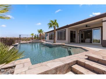 Beautiful backyard pool with spa, and lush landscaping, ideal for outdoor entertaining and relaxation at 1950 Colvin Run Dr, Henderson, NV 89052