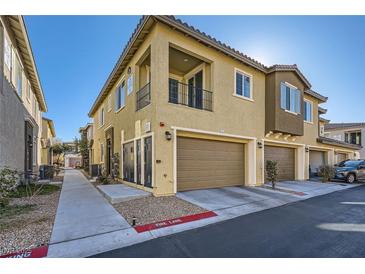 Inviting two-story home featuring a private balcony, garage, and charming architectural details at 25 Barbara Ln # 42, Las Vegas, NV 89183