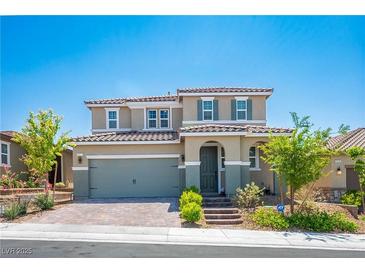 Charming two-story home featuring a well-manicured lawn, tile roof and a two-car garage at 2577 Tolmezzo St, Henderson, NV 89044
