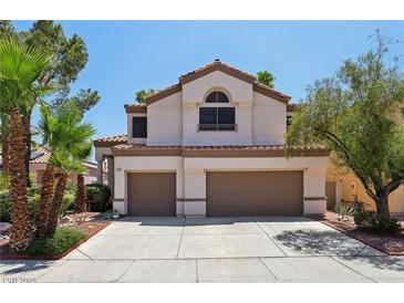 Charming home featuring a tile roof, desert landscaping, and an attached two-car garage at 3320 Indian Moon Dr, Las Vegas, NV 89129