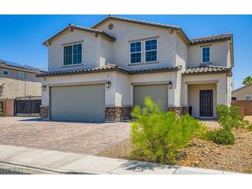 Inviting two-story home featuring a two-car garage and charming desert landscaping at 5660 Oasis Ridge St, North Las Vegas, NV 89031