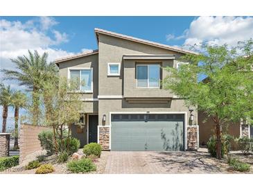 Charming two-story home with landscaped yard, stone accents, and a two car garage at 9238 Bluemist Falls St, Las Vegas, NV 89123