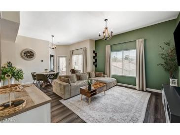Bright living area features a comfortable sofa, decorative rug, modern lighting, and stylish furnishings at 9303 Gilcrease Ave # 2234, Las Vegas, NV 89149