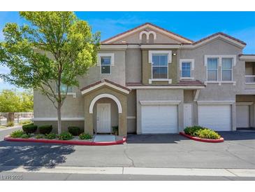 Charming townhome with well-maintained landscaping, attached garage and inviting front entryway at 9975 Peace Way # 2009, Las Vegas, NV 89147
