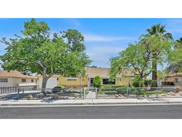 Charming single-story home featuring mature trees and a well-maintained front yard at 1331 Melville Dr, Las Vegas, NV 89102