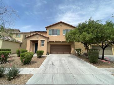 Two-story home featuring a two car garage, neutral color palette and drought resistant landscaping at 5709 Nobleton Ct, North Las Vegas, NV 89081