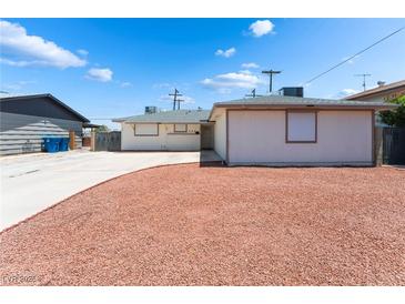 Charming single-story home featuring a well-maintained front yard with tasteful desert landscaping at 704 N Wallace Dr, Las Vegas, NV 89107