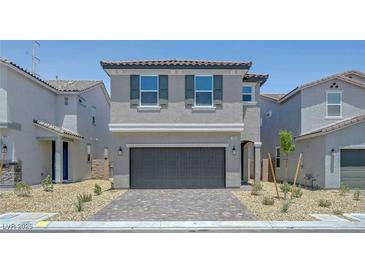 Charming two-story home with a gray exterior, well-manicured landscaping, and a two-car garage at 7086 Parkallen Ave, Las Vegas, NV 89113