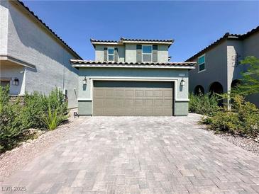 Two-story home features a wide driveway, two-car garage, and simple landscaping for great curb appeal at 9348 Wildcat Peak St, Las Vegas, NV 89178