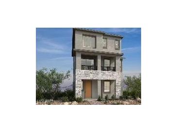 Modern three-story home featuring stone accents, a small balcony, and large windows at 1536 Little Penguin St, Las Vegas, NV 89138