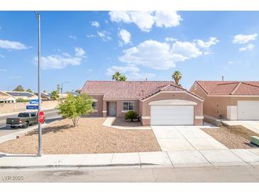 Charming single-story home with a well-maintained front yard and a two-car garage at 2403 Sexton Ave, North Las Vegas, NV 89031