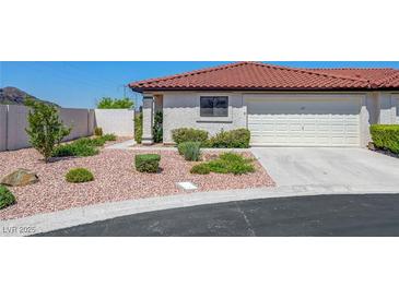 Charming single-story home with a well-manicured front yard and a two-car garage at 454 Intrepid Ct, Boulder City, NV 89005