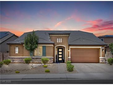Charming single-story home featuring a well-manicured front yard and a spacious two-car garage at 9015 Chopper Prairie St, Las Vegas, NV 89131
