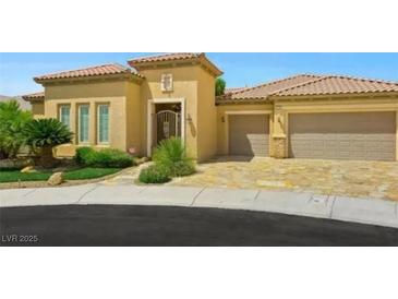 Inviting single-story home showcasing a well-manicured yard, desert landscaping and a two-car garage at 2156 Farmington Bay Ct, Henderson, NV 89044