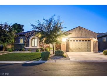 Charming single-story home with a well-manicured lawn and a two-car garage at twilight at 2172 De Rouge Ave, Henderson, NV 89044