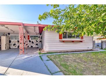Charming single-story home showcasing a quaint covered patio, tidy lawn, and unique stone accents at 304 Perkins Cir, Las Vegas, NV 89106