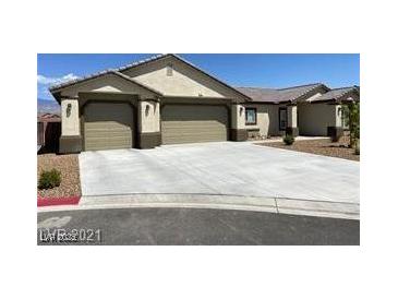 Beautiful single-story home with a spacious driveway and attached two-car garage at 31 White Burch Ln, Pahrump, NV 89048