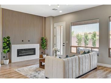 Bright living room featuring fireplace, modern wall design, plush seating, and stylish decor at 3218 Squire St, Las Vegas, NV 89135