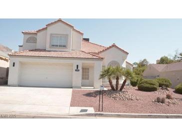 Charming two-story home with a tile roof, a two-car garage, and desert landscaping at 7253 Alsop Ct, Las Vegas, NV 89156