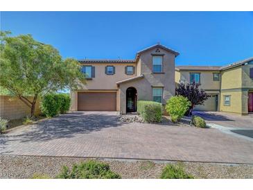 Charming two-story home featuring a desert landscape and a spacious driveway at 9542 Ridgeglen Ct, Las Vegas, NV 89148