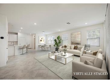 Bright, open-concept living room featuring modern decor and neutral tones at 3270 Trabia Ave, Henderson, NV 89044