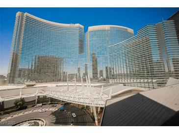 Striking view of a high-rise building featuring unique architecture and a sleek, modern design against a bright blue sky at 3726 Las Vegas Blvd # 704, Las Vegas, NV 89158