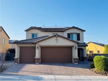 Charming two-story home with a three-car garage and a meticulously brick paved driveway at 4076 Topaz Hills Dr, North Las Vegas, NV 89032