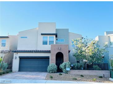 Contemporary two-story home featuring a two-car garage, desert landscaping, and a private front entrance at 6230 Bravestar Ct, Las Vegas, NV 89141