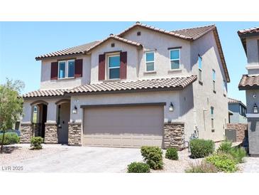 Two-story home featuring a desert landscaped yard, a two-car garage, and a classic red-tile roof at 8186 Guadiano Ave, Las Vegas, NV 89113