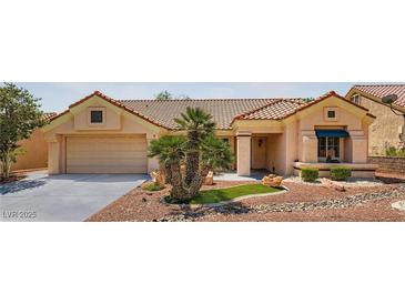 Charming single story home with a desert landscape, a two-car garage, and a red tile roof at 9717 Buckhorn Dr, Las Vegas, NV 89134