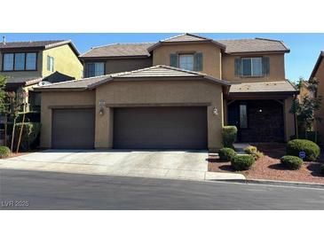 Charming two-story home featuring a three-car garage and well-manicured landscaping at 10668 Berkshire Woods Ave, Las Vegas, NV 89166