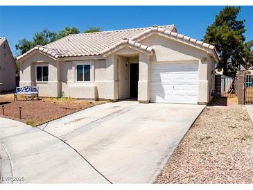 Charming single story home featuring a tile roof, two car garage and well manicured landscaping at 1709 High Breeze Ct, Las Vegas, NV 89106