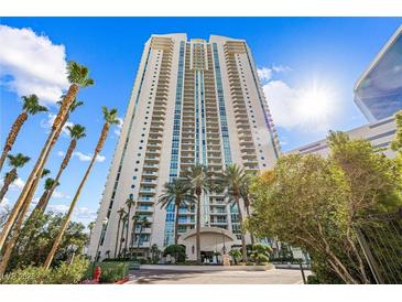 High-rise exterior view with tall palm trees and a bright blue sky in the background at 2877 Paradise Rd # 702, Las Vegas, NV 89109