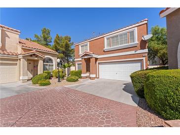 Charming two-story townhome with a tile roof, well-maintained landscaping, and an attached two-car garage at 3221 Epson St, Las Vegas, NV 89129