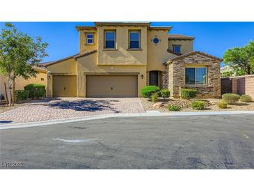 Charming two-story home with a well-manicured lawn, three car garage, and stylish stone accents at 397 Pearl Fountains Ct, Las Vegas, NV 89148