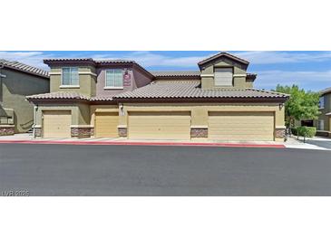 Attractive condo building featuring multiple attached garages in a well-maintained community at 6868 Sky Pointe Dr # 1107, Las Vegas, NV 89131