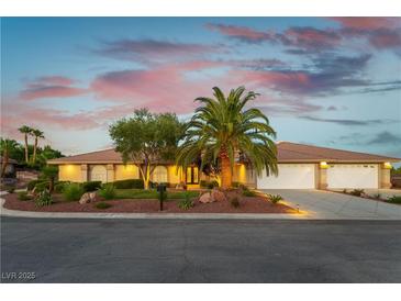 Charming single-story home featuring a well-manicured front yard, mature landscaping, and a three-car garage at 8650 W Verde Way, Las Vegas, NV 89149