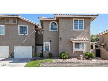 Charming townhome featuring a two-car garage and well-manicured front yard, perfect for comfortable living at 9270 Apache Springs Dr, Las Vegas, NV 89117